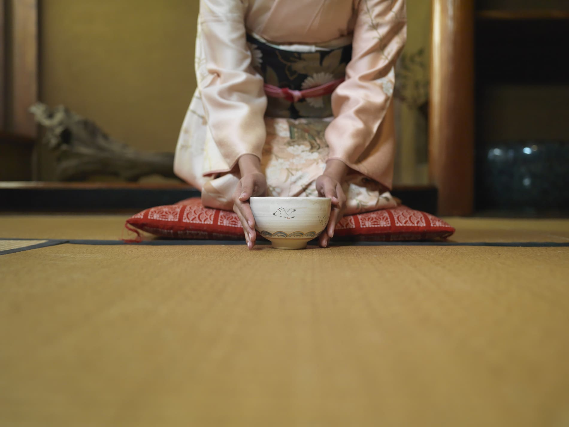Woman kneeling down tea bowl