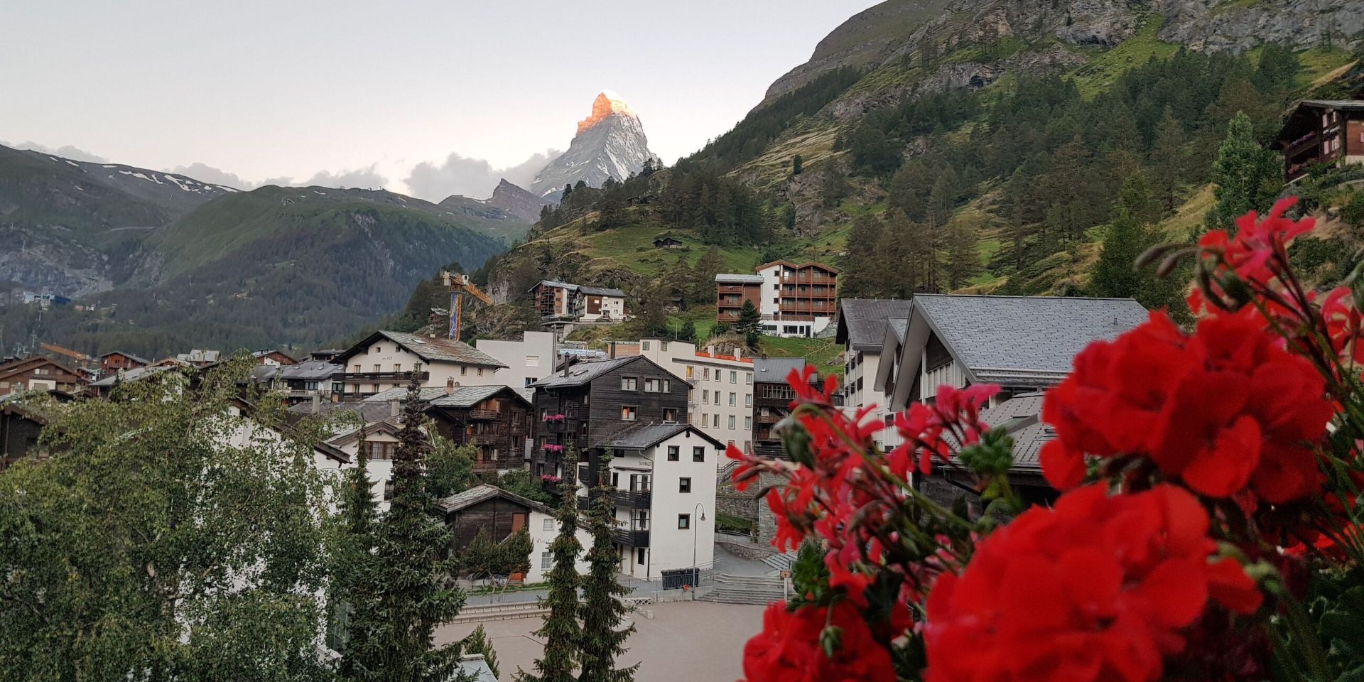 A view of a town in Austria with mountains in the background