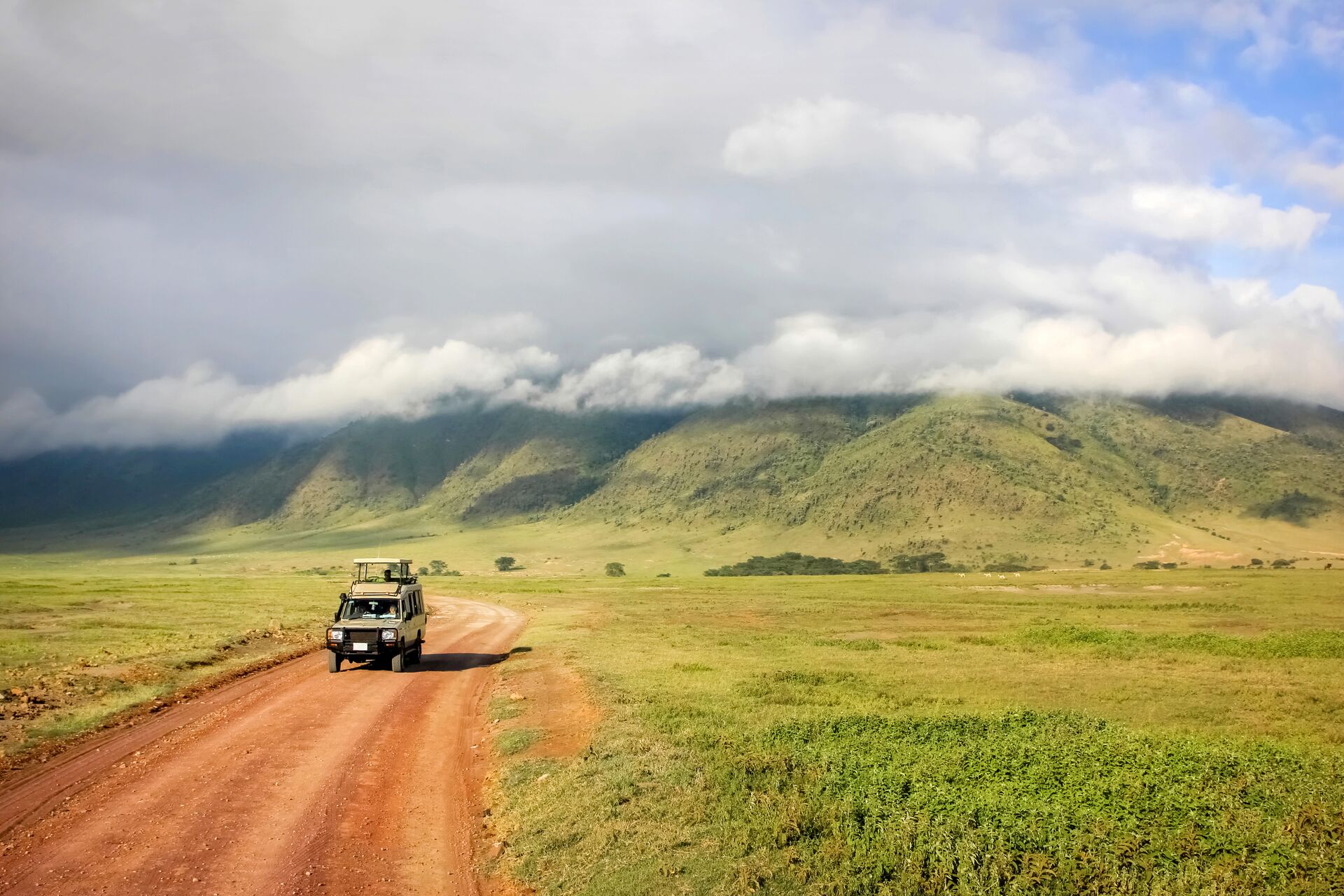 Safari Jeep with Ngorongoro Crater National Park in the background in Tanzania, Africa