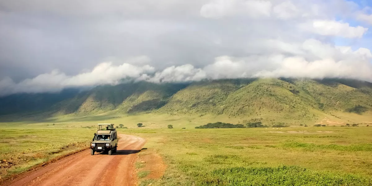 Safari Jeep with Ngorongoro Crater National Park in the background in Tanzania, Africa