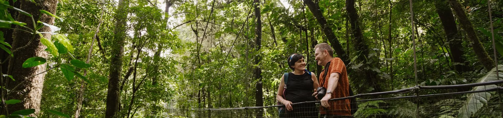 Two adults on a bridge on a Trafalgar tour in Costa Rica