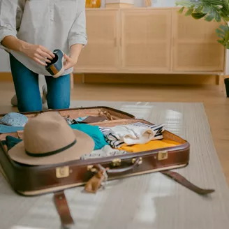 Woman Packing A Suitcase
