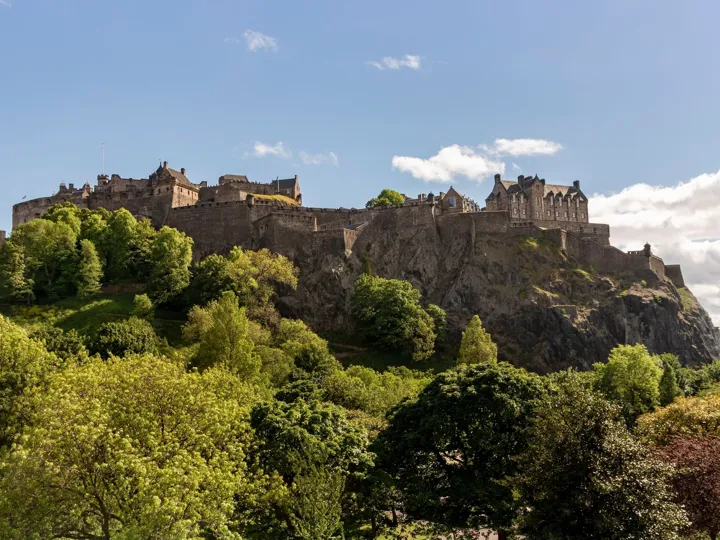 Blue skies and white fluffy clouds above Edinburgh Castle in Scotland