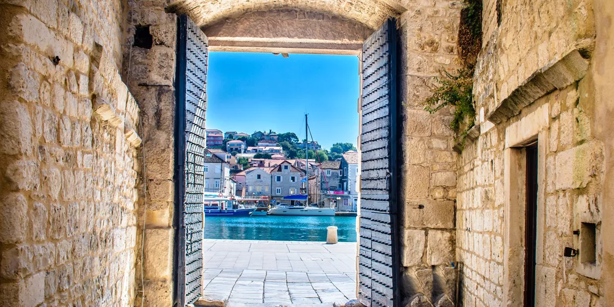 Gate opening onto the harbour in Trogir, Croatia