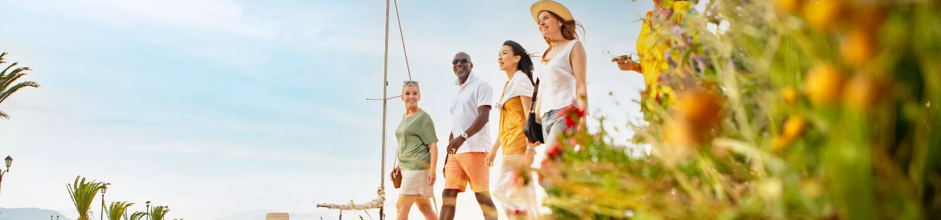 Tour guests on a waterfront walk smiling