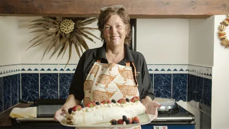 Woman holding meringue with fruits