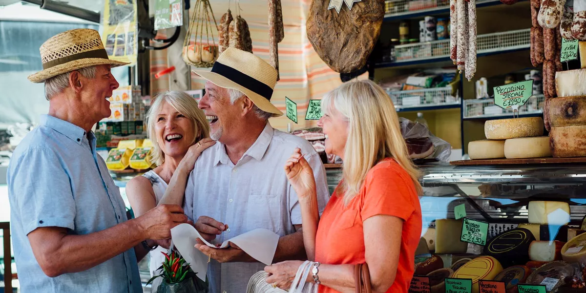 Couples Chatting while they shop in an Italian delicatessen