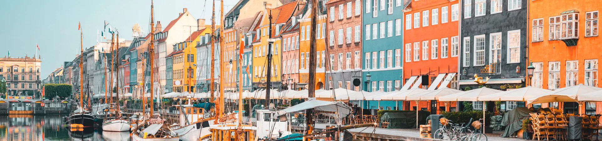 Colourful Townhouses Facades And Old Ships Along The Nyhavn Canal, Copenhagen