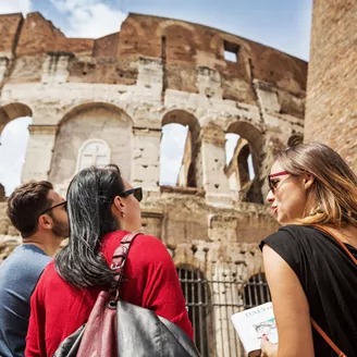 Guide Explaining To Tourists The Coliseum Of Rome