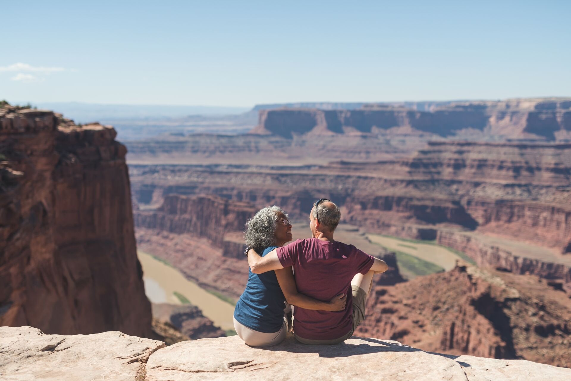 Senior couple sitting on the rock in Utah Desert