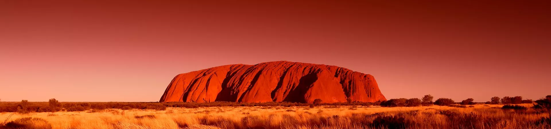 Uluru in Australia against a red sky