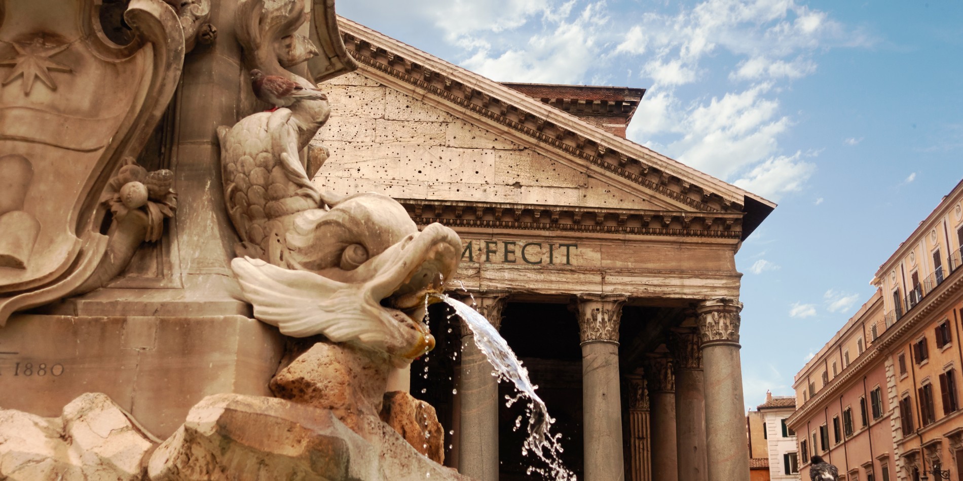 Fountain with sculptures in front of entrance to Pantheon in Rome, Italy