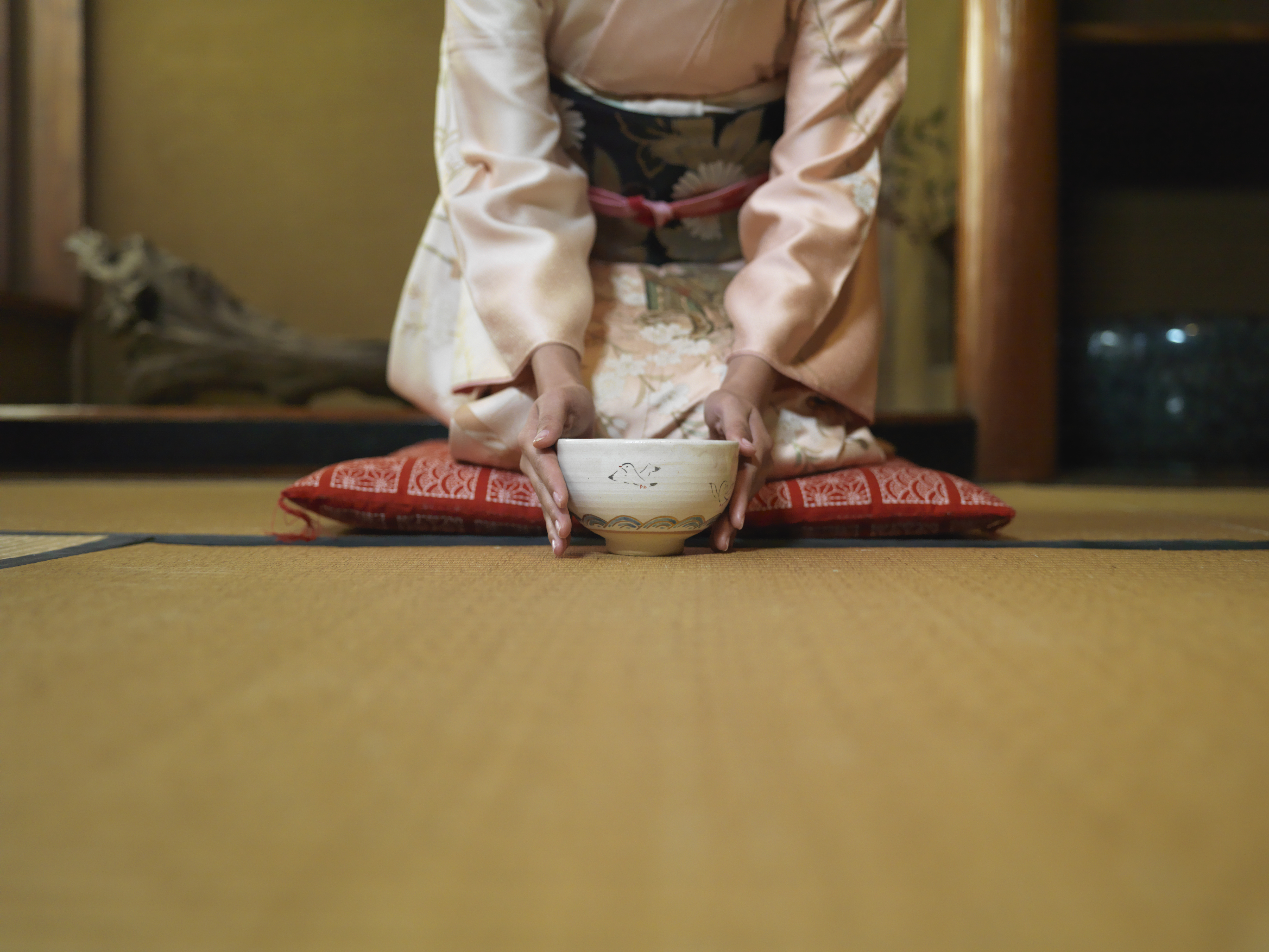 Woman Kneeling Down and holding a Tea Bowl
