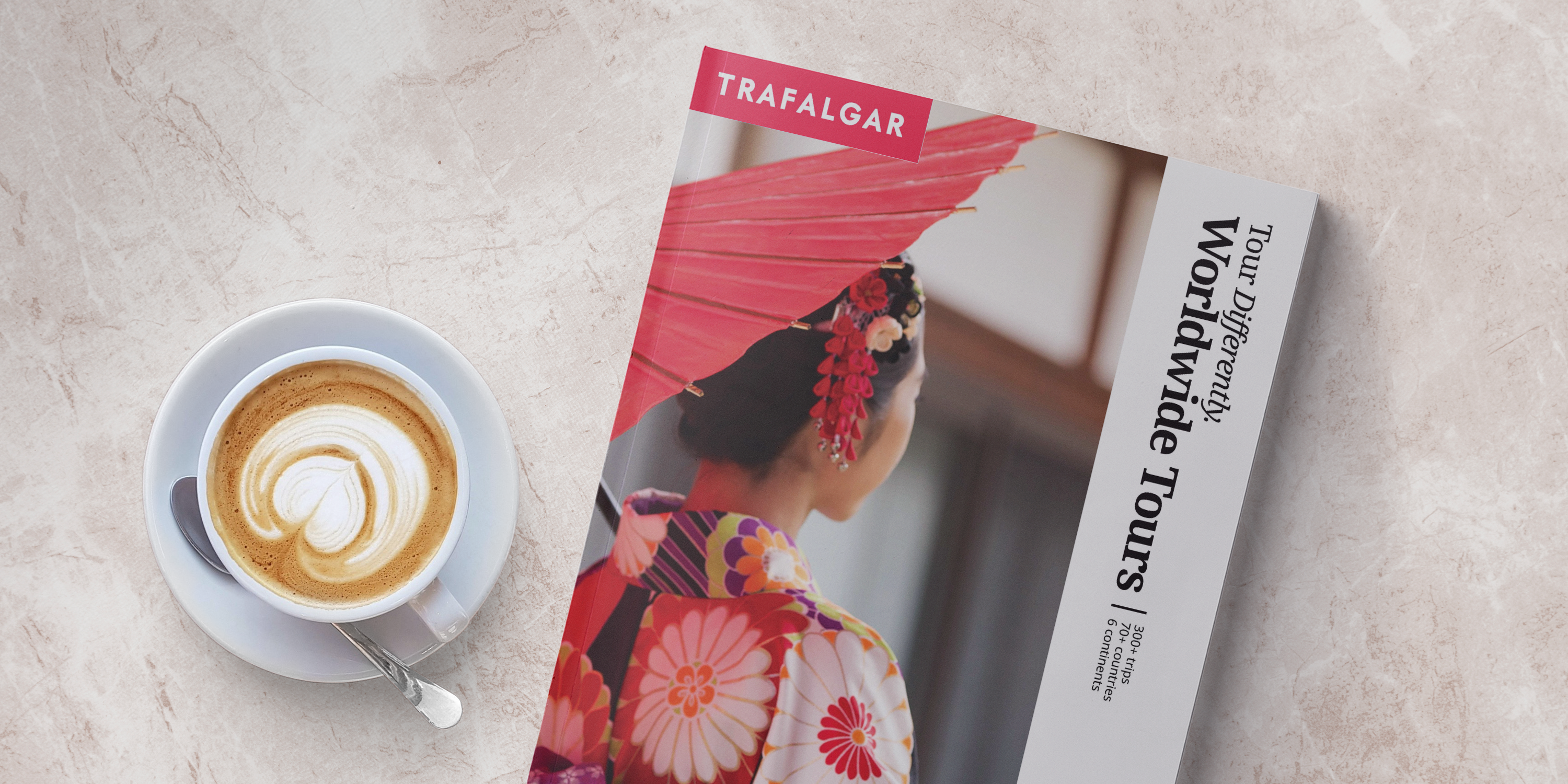 Trafalgar worldwide brochure next to a cup of coffee