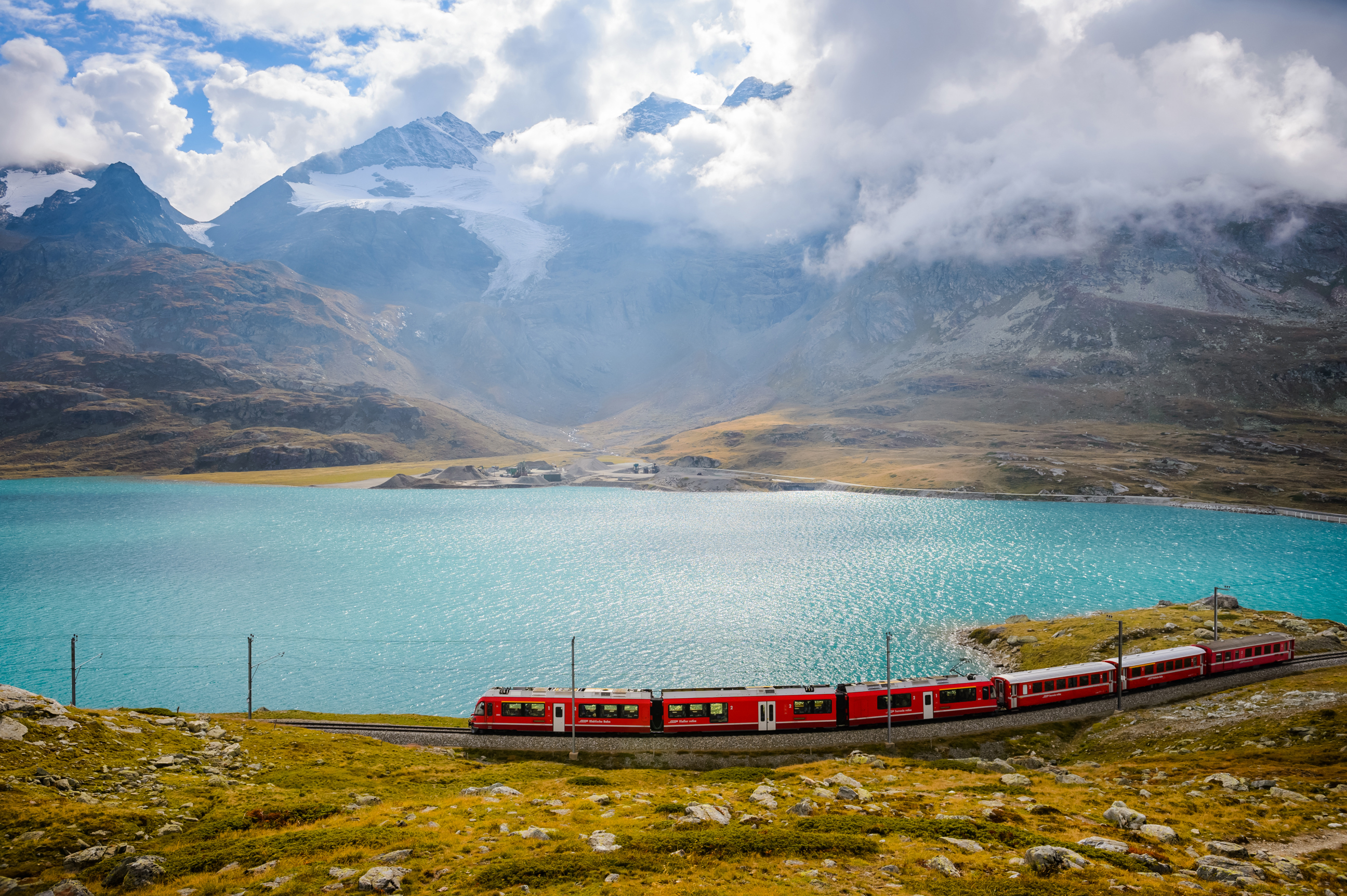 overlooking-view-of-train-running-on-the-bernina-railway-in-switzerland-626077868.jpg