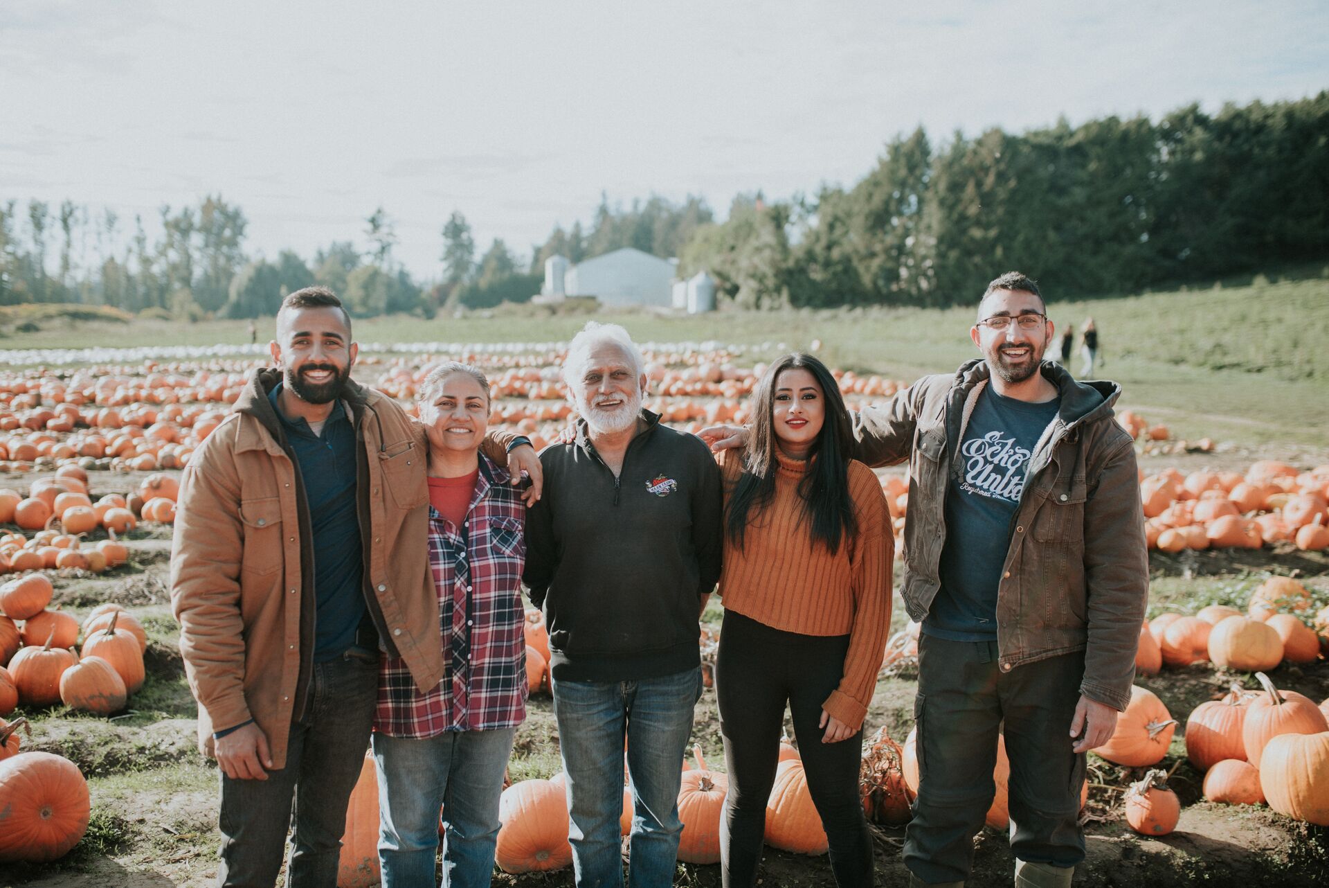 Kris And His Family on pumpkin field at Maan Farms in Fraser Valley, Canada