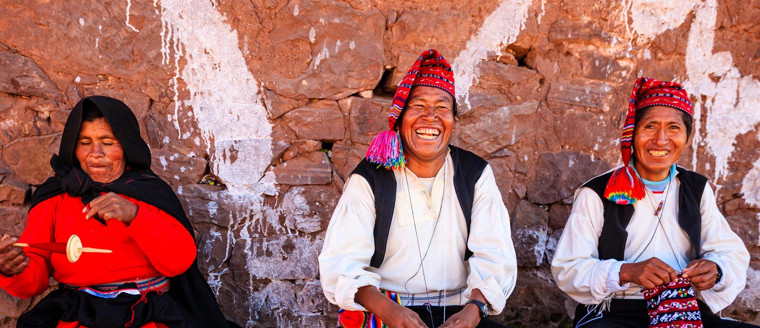 Three people knitting using traditional Peruvian techniques 