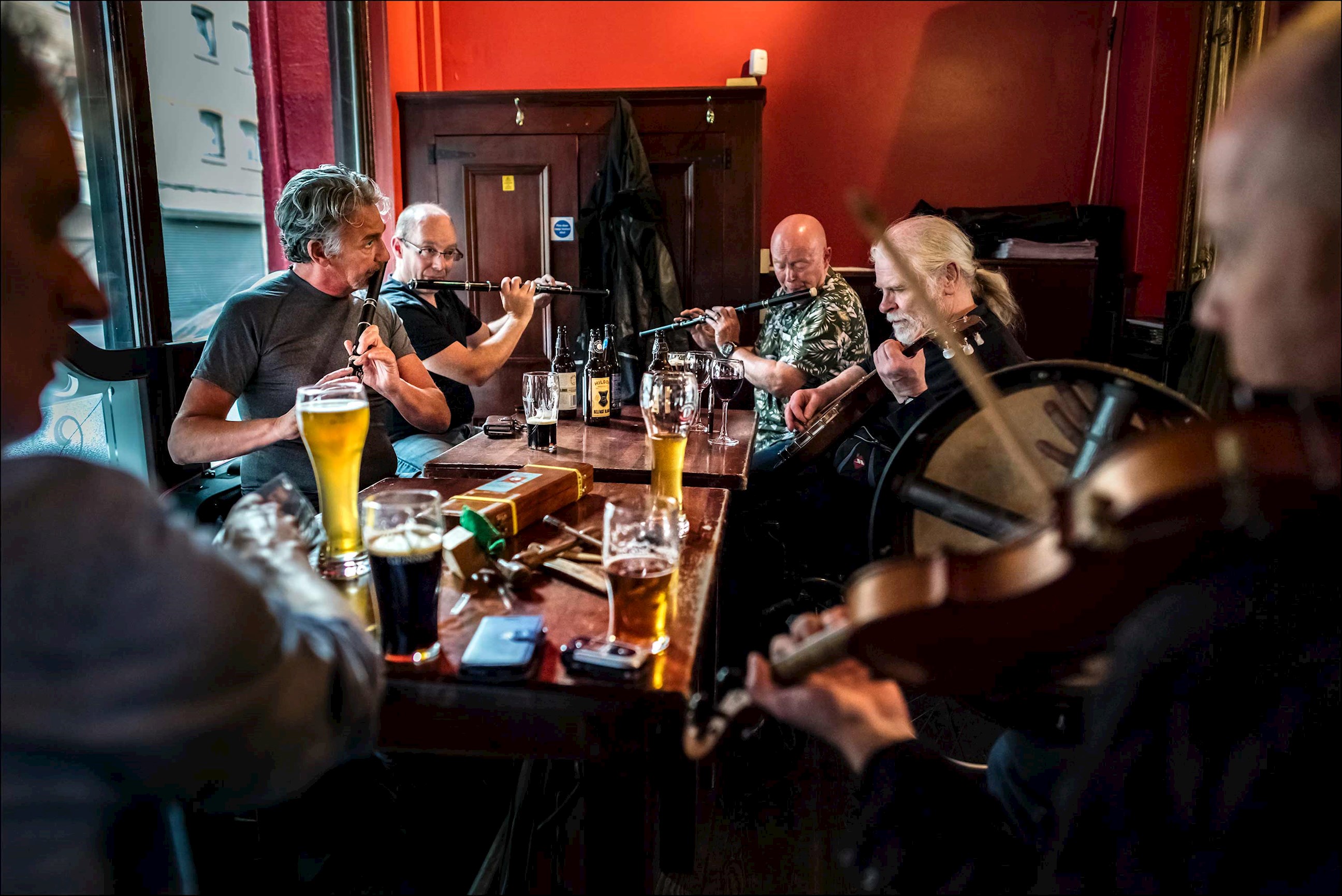 Traditional Irish music session in a pub with drinks