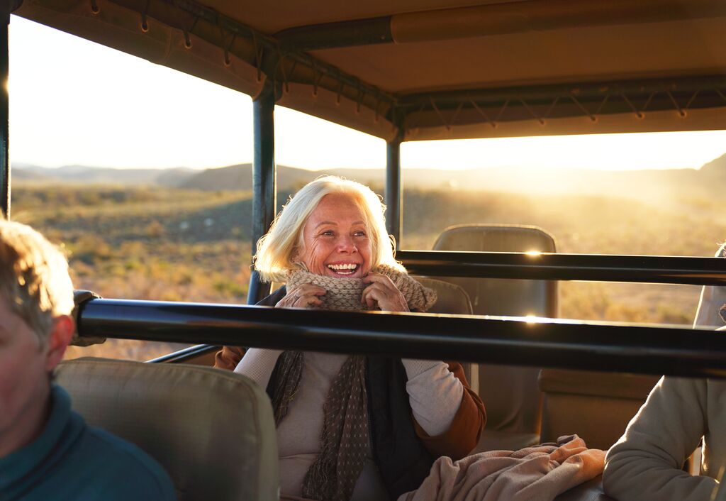 Medium Happy Senior Woman On Safari Riding In Off Road Vehicle 1365337910
