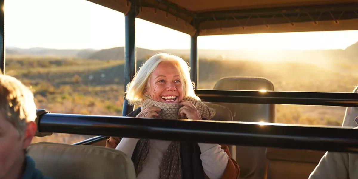 Medium Happy Senior Woman On Safari Riding In Off Road Vehicle 1365337910