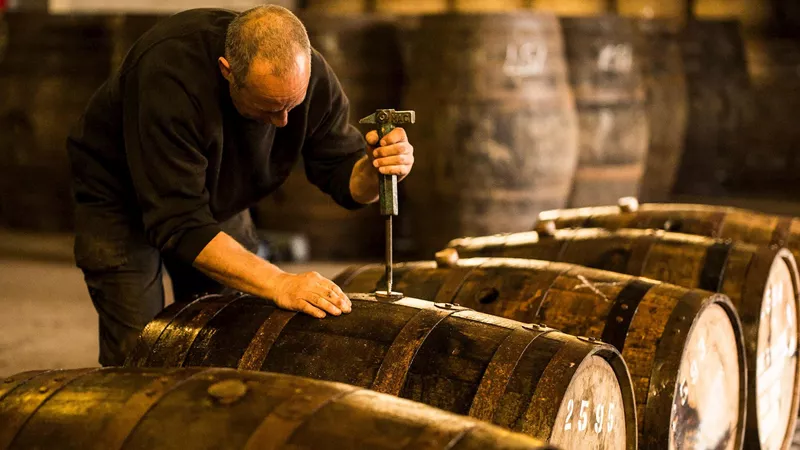 Man Opening Whisky Cask, Glasgow, Scotland