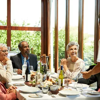 Sommelier talking to a group of friends in a restaurant