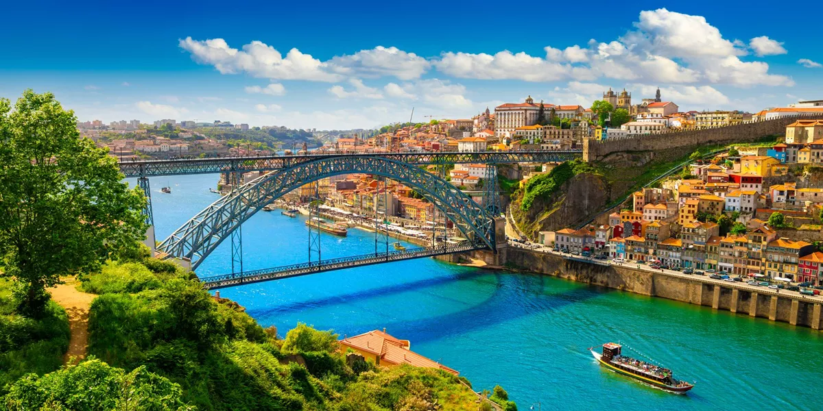 Porto, Lisbon with a traditional Rabelo boat sailing along the Duoro River