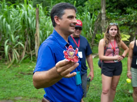 Don Alberto Holding Flower in garden of Hacienda Pozo Azul in Costa Rica
