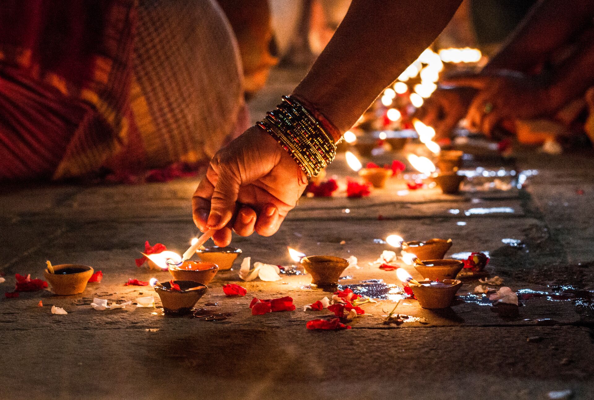 Close Up Of Hand Holding Illuminated Candles