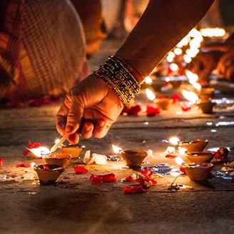 Close Up Of Hand Holding Illuminated Candles