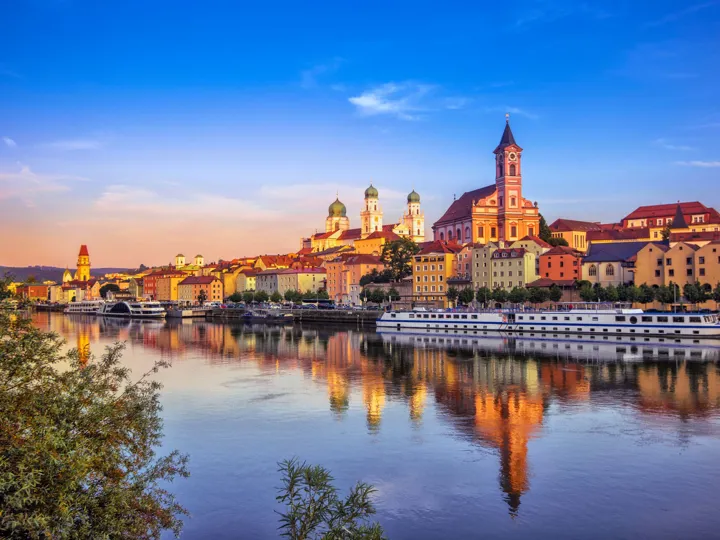 The waterfront and sightseeing boats in Passau in Germany at sunset