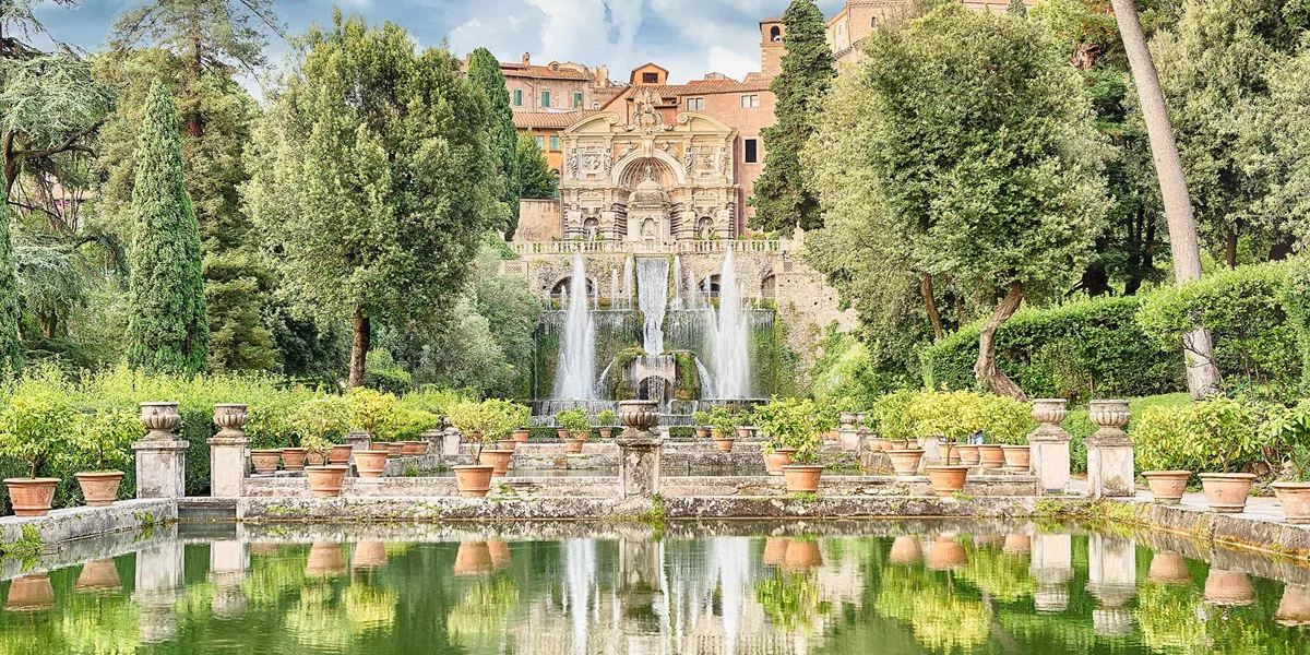 Villa d’Este in Tivoli with fountains, terraced gardens and reflective pool surrounded by greenery