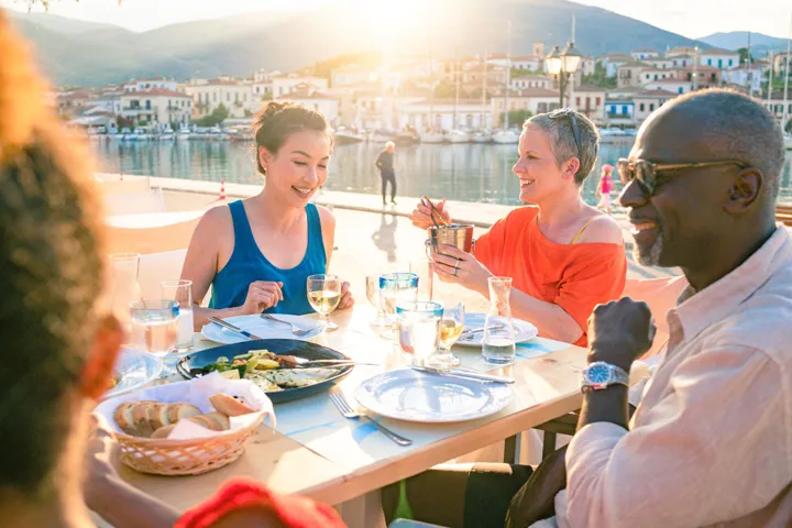 Guests enjoying a waterfront dinner at Galaxidi, Greece