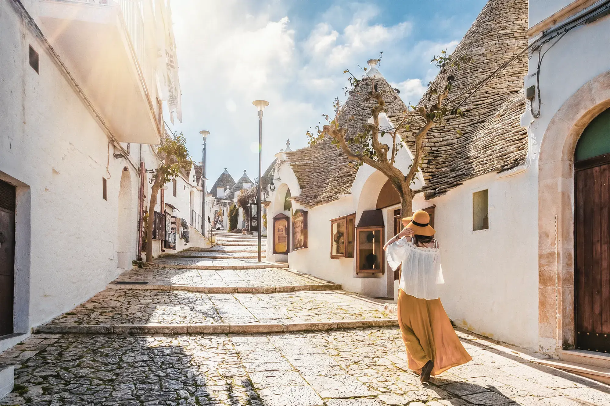 day-hero-tourist-walking-alberobello-puglia.webp