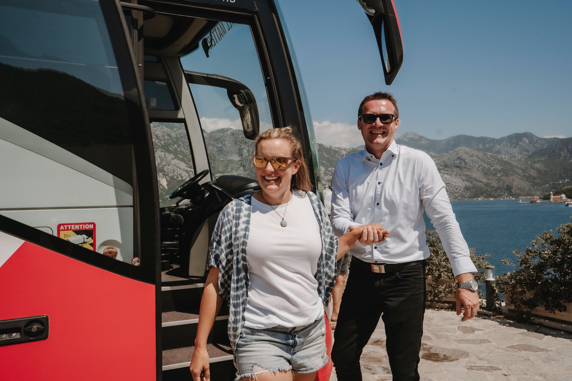 Driver helping guest off Trafalgar Tour Coach