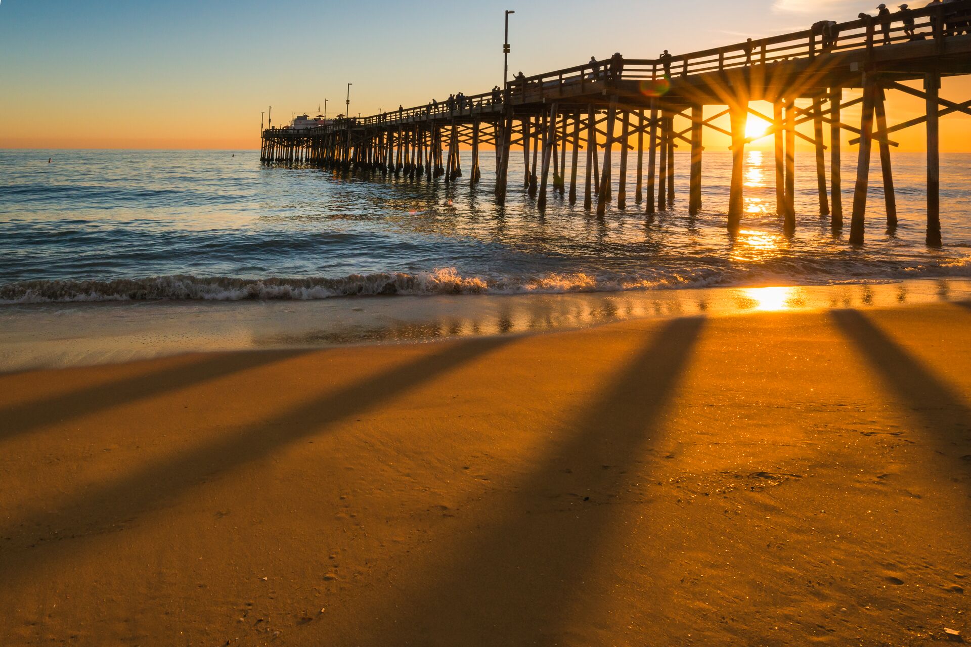 Sun setting behind a pier in California, USA