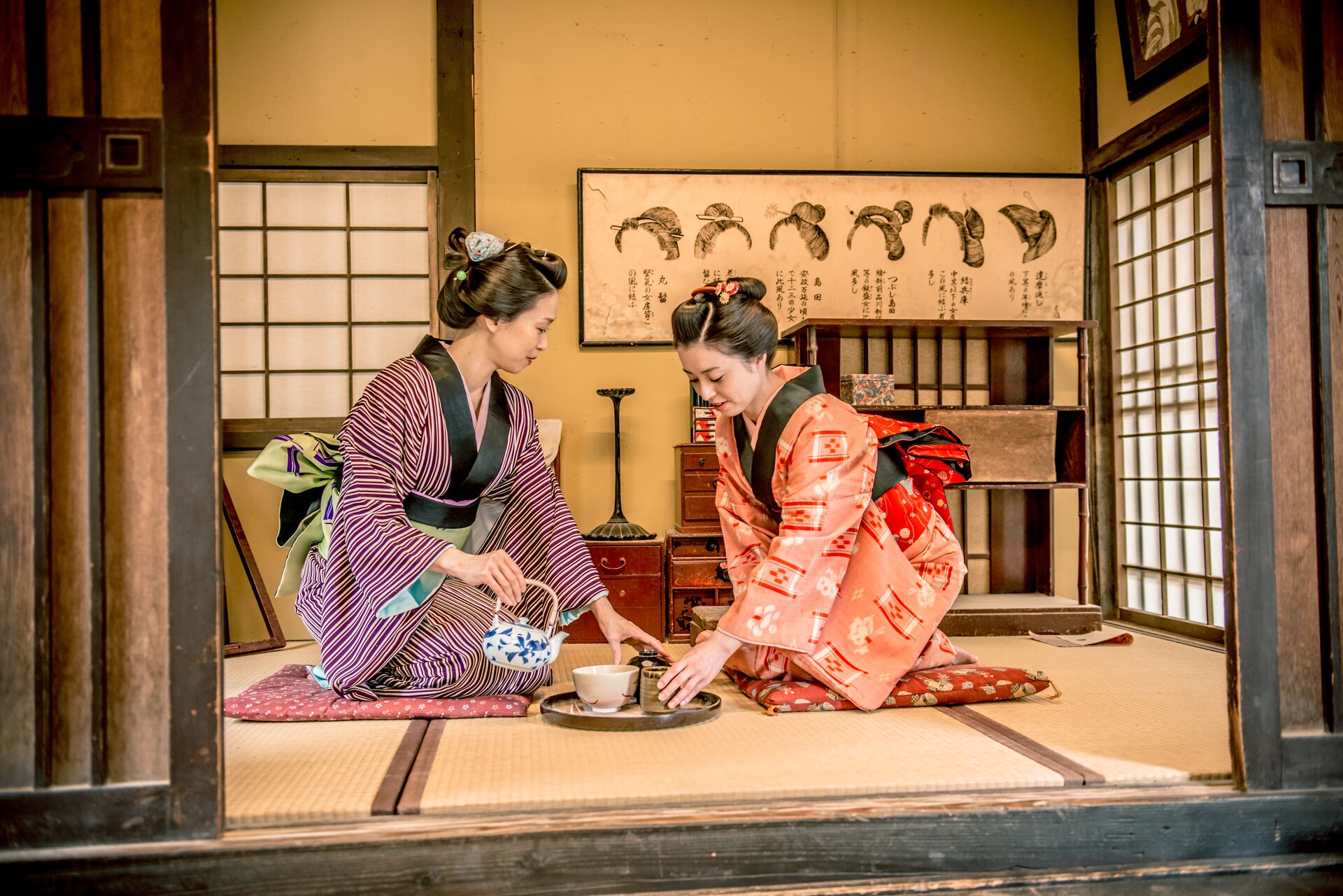 Women in Kimono drinking matcha tea during a traditional Tea Ceremony in Kyoto, Japan