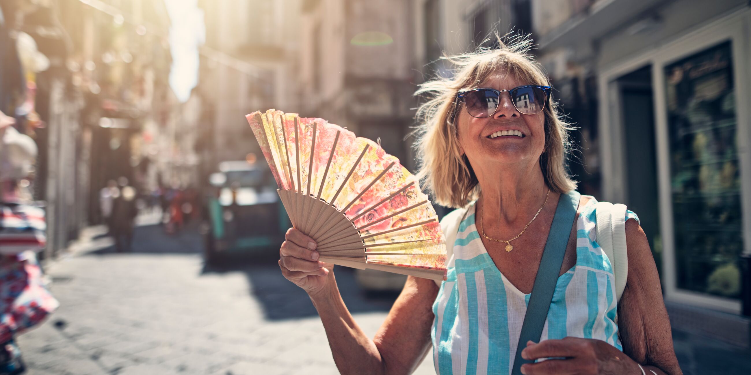 Senior woman sightseeing small Italian town