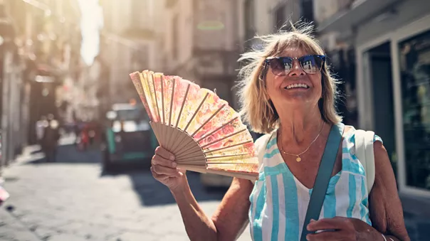 Senior woman sightseeing small Italian town