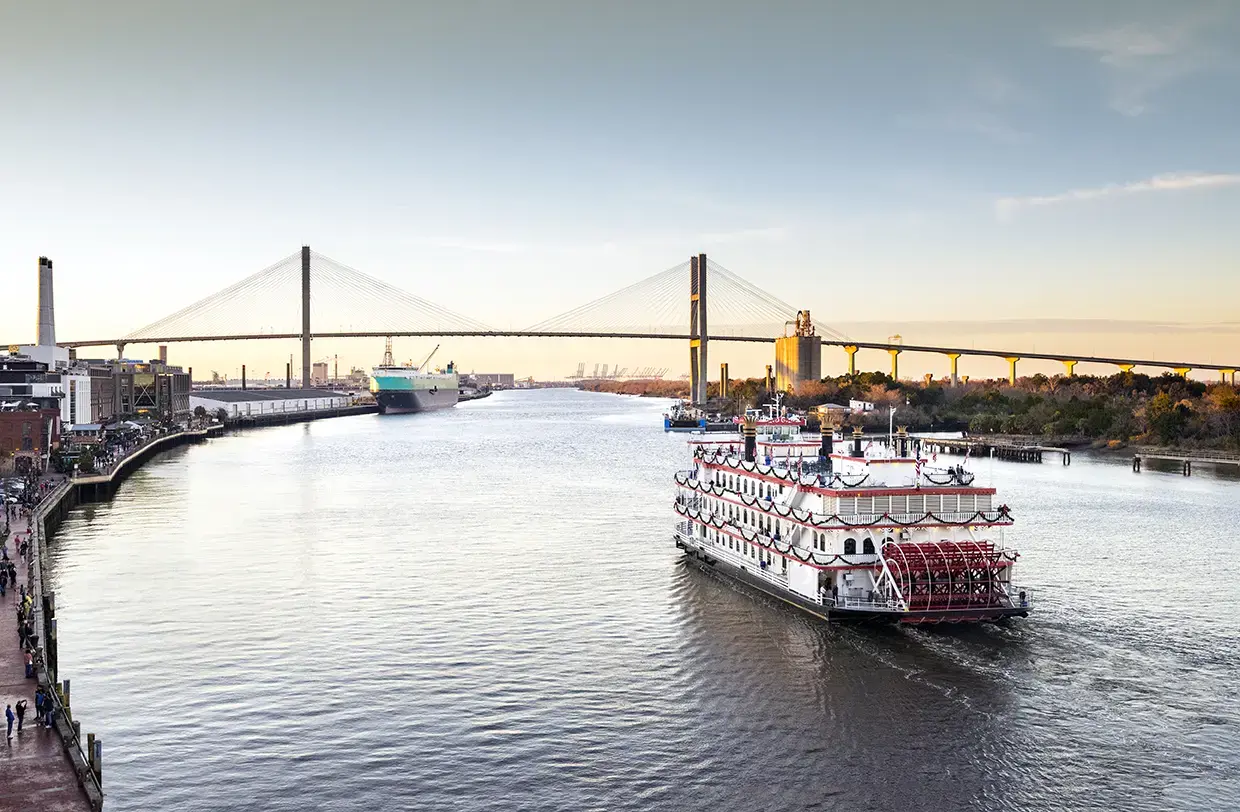 Riverboat cruising along a river in Savannah, Georgia, USA