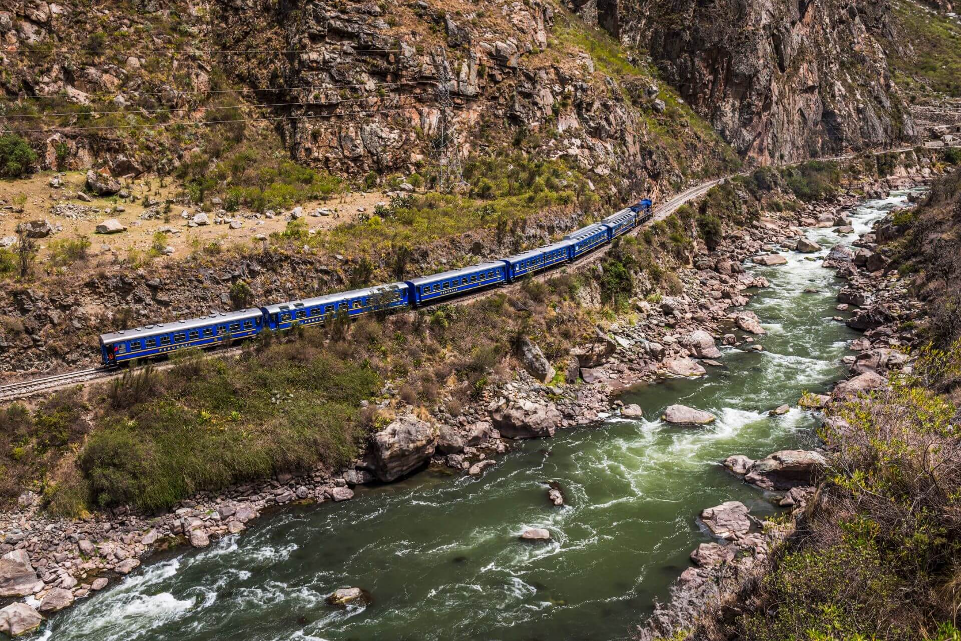 Train to Machu Picchu moving near the river