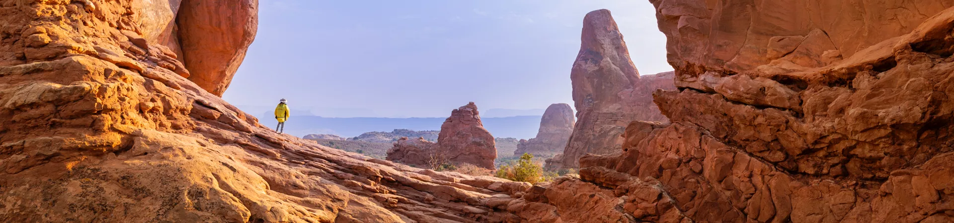 Tourist hiking in Arches National Park, USA