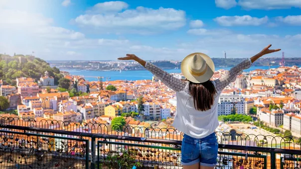 A Happy Tourist Woman Overlooks The Colorful Old Town Alfama Of Lisbon City 1397795142