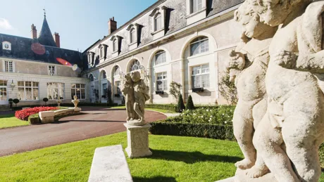 Sculptures next to the entrance to Chateau De Beauvois in France