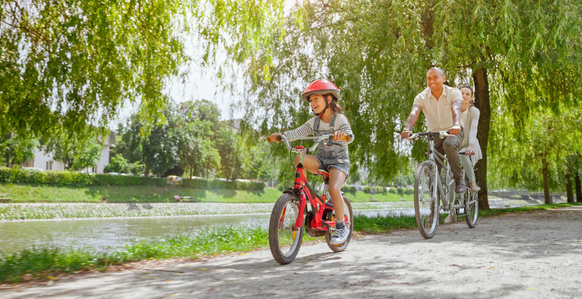 Family riding bikes together on a sunny day