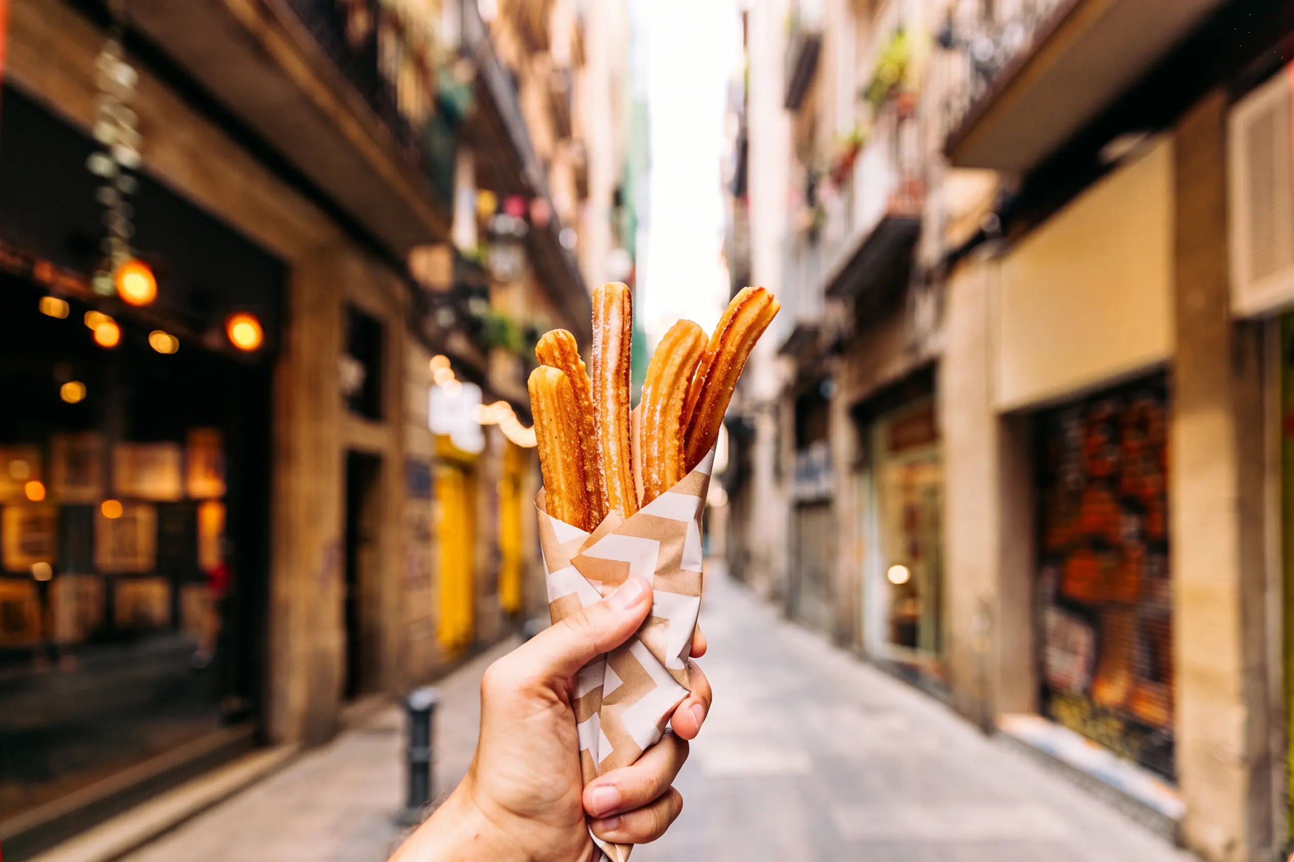 day-hero-eating-churros-on-the-street-in-gothic-quarter-madrid-spain.webp