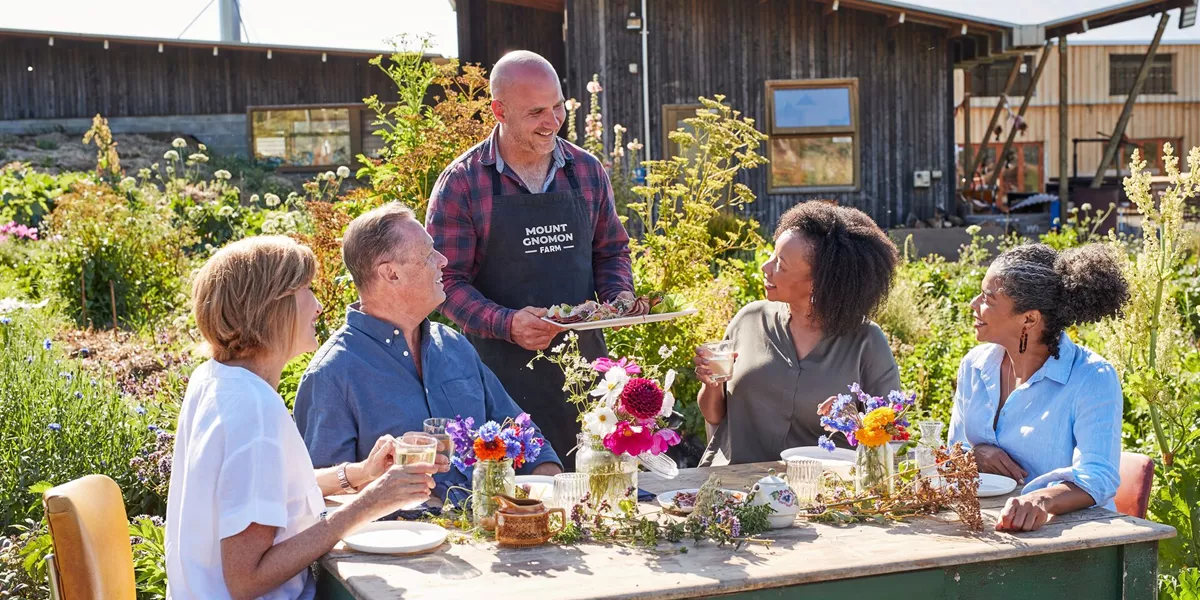 Be My Guest Experience, with food on a table of flowers