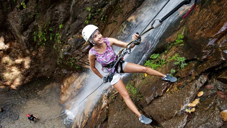 Girl propelling down a waterfall
