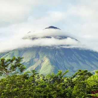 Arenal Volcano in Costa Rica with a jungle in the foreground