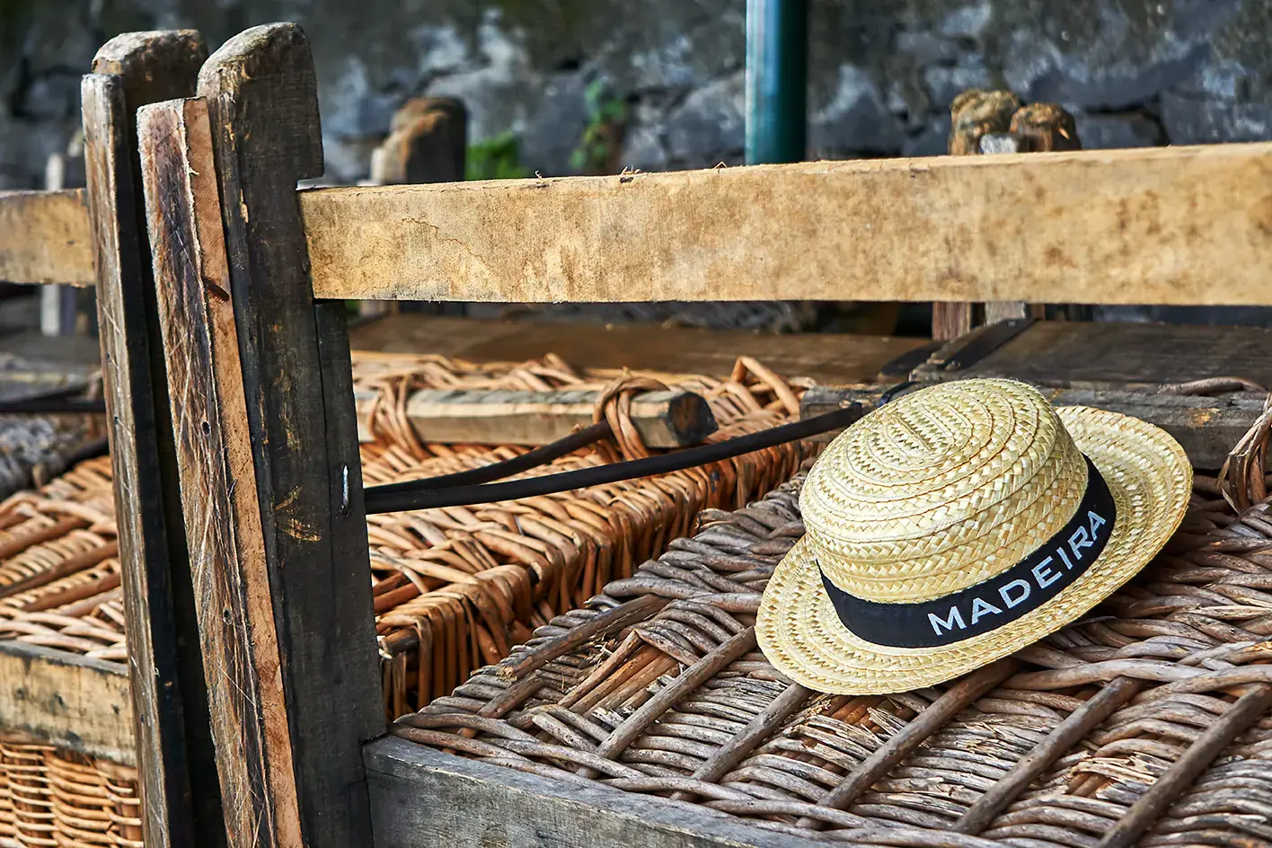 straw-hat-on-a-toboggan-in-madeira.webp